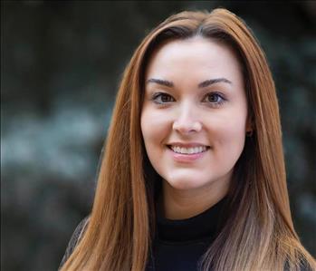 A women posing for a photo outdoors